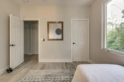 a bedroom with white walls and a window and a bed at LA COSTA Valley Newly Remodeled Gem in Carlsbad