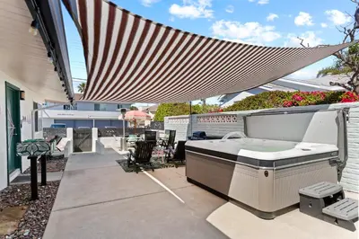 a hot tub on the patio of a house at Amazing Place by the Sea - O'side Palms in Oceanside