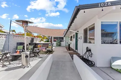 a patio of a house with an umbrella at California Dreamin at O'side Palms in Oceanside