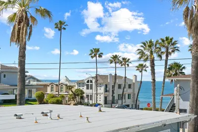 a view of palm trees and the ocean at California Dreamin at O'side Palms in Oceanside