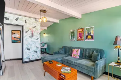 a living room with a couch and a table at Day in Paradise at Oside Palms in Oceanside