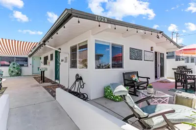 a white house with chairs and a patio at Day in Paradise at Oside Palms in Oceanside