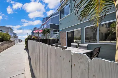 a wooden fence in front of a house at Stunning Beach Haven! Steps to the Beach & Pet Friendly! in San Diego