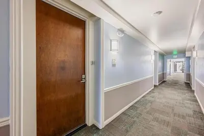 a hallway with a wooden door in a building at F107 - Oh Bouy in Oceanside