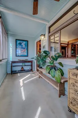 a living room with a potted plant and a television at The Craftsman Coastal Cottage in Leucadia in Encinitas