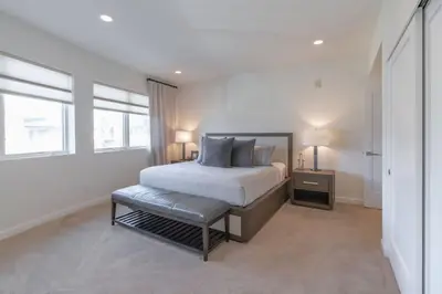 a bedroom with a bed and a bench in it at Beachside Paradise in Windansea in San Diego