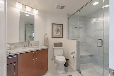 a bathroom with a shower and a toilet and a sink at Beachside Paradise in Windansea in San Diego