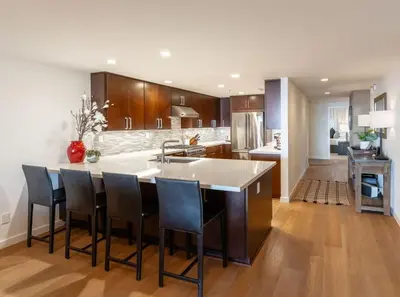 a kitchen with a large island with bar chairs at Beachside Paradise in Windansea in San Diego