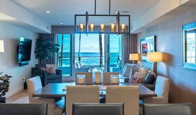 a living room with a table and a dining room at Beachside Paradise in Windansea in San Diego