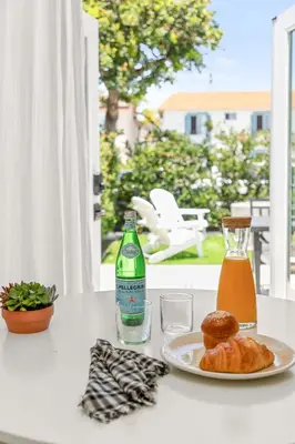 a table with a plate of food and a bottle of soda at Modern and Cozy in PB with Patio and Firepit in San Diego