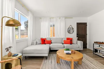 a living room with a couch and a table at Modern and Cozy in PB with Patio and Firepit in San Diego
