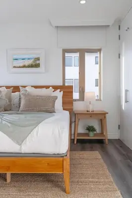 a bedroom with a large bed and a table at Oceanfront Townhome with Breathtaking Views in San Diego