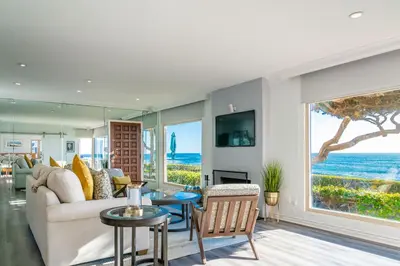 a living room with a couch and a view of the ocean at Oceanfront Townhome with Breathtaking Views in San Diego
