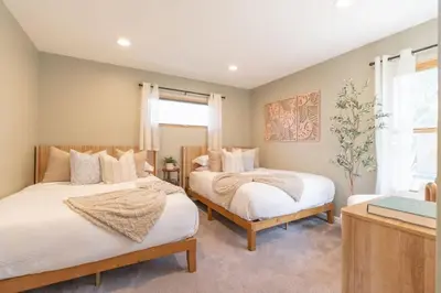 a bedroom with two beds and a window at Perched Ocean Paradise in San Diego