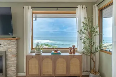 a living room with a window with a view of the ocean at Perched Ocean Paradise in San Diego