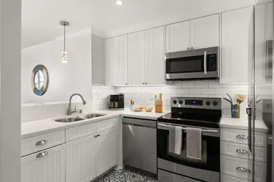 a white kitchen with a stove and a microwave at Prime Mission Beach Getaway in San Diego