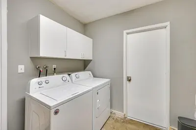 a white laundry room with a washer and dryer at Fireplace, Hot Tub, Patio and BBQ San Diego Home in Spring Valley