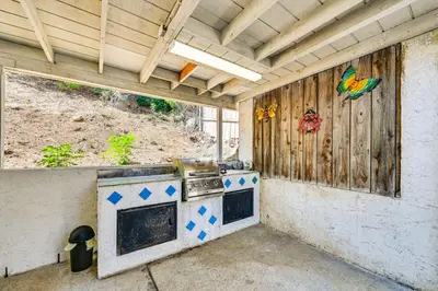 an outdoor kitchen with a stove in a building at Fireplace, Hot Tub, Patio and BBQ San Diego Home in Spring Valley