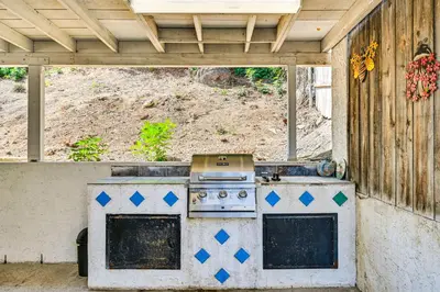an outdoor kitchen with a stove in a backyard at Fireplace, Hot Tub, Patio and BBQ San Diego Home in Spring Valley