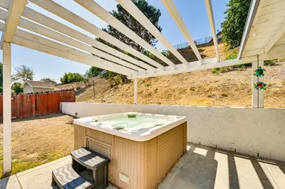 a hot tub on a patio under a pergola at Fireplace, Hot Tub, Patio and BBQ San Diego Home in Spring Valley