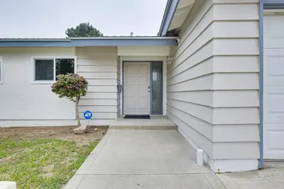 a white house with a door on the side of it at Fireplace, Hot Tub, Patio and BBQ San Diego Home in Spring Valley