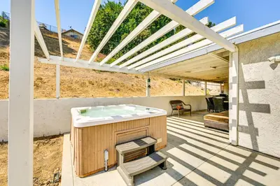 a hot tub on a patio with a pergola at Fireplace, Hot Tub, Patio and BBQ San Diego Home in Spring Valley
