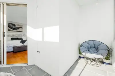 a room with a chair and a bed and a mirror at Ocean View Gem with Rooftop Deck and Hot Tub in San Diego