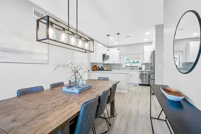 a kitchen and dining room with a wooden table and chairs at Ocean View Gem with Rooftop Deck and Hot Tub in San Diego