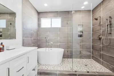 a bathroom with a tub and a glass shower at Ocean View Gem with Rooftop Deck and Hot Tub in San Diego