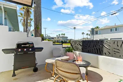 a patio with a grill and chairs and a table at O'side Palms Multi Units in Oceanside
