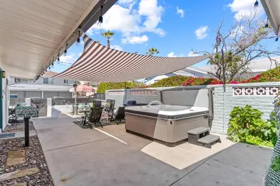 a backyard patio with a grill and a hammock at O'side Palms Multi Units in Oceanside