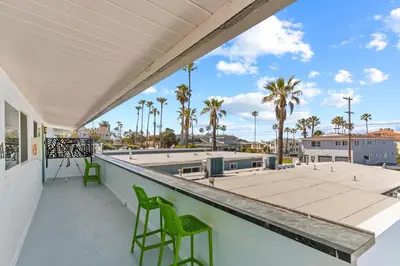 a balcony with chairs and a view of the ocean at O'side Palms Multi Units in Oceanside