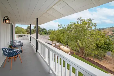 a white porch with two chairs and a table at Fallbrook's Finest Hideaway in Fallbrook