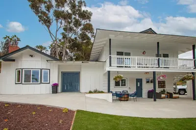 a white house with a balcony and a patio at Fallbrook's Finest Hideaway in Fallbrook