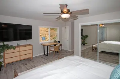 a bedroom with a flat screen tv and a bed at Fallbrook's Finest Hideaway in Fallbrook