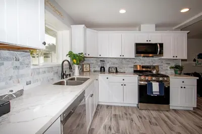 a kitchen with white cabinets and a sink at Fallbrook's Finest Hideaway in Fallbrook