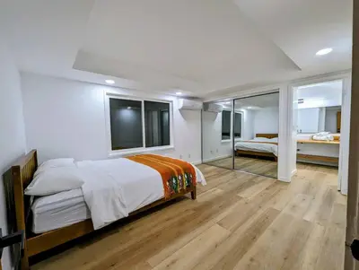 a bedroom with a large bed and a large mirror at La Jolla Retreat in San Diego