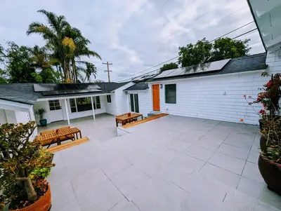 a patio with two benches and a house at La Jolla Retreat in San Diego