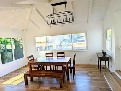 a dining room with a table and chairs and a chandelier at La Jolla Retreat in San Diego