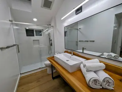 a bathroom with a sink and a shower and a mirror at La Jolla Retreat in San Diego