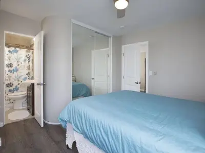 a bedroom with a blue bed and a bathroom at Ocean Front, Steps Mission Beach, Bay, Remodeled, Mission Beach Jamaica FLAT in San Diego