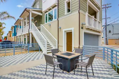 a patio with chairs and a table in front of a building at Newly Built Bayside Dream, Fire Pit & Bay Views in San Diego