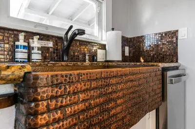 a kitchen with a brick counter with a sink at Bankers Hill Hideaway with AC Views and Parking in San Diego