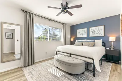 a bedroom with a bed and a ceiling fan at Oceanside Oasis - King Bed, Pet Friendly, Fire Pit in Oceanside