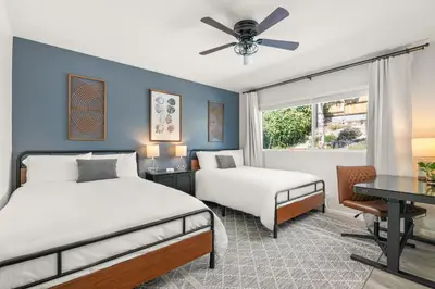 a bedroom with two beds and a desk and a window at Oceanside Oasis - King Bed, Pet Friendly, Fire Pit in Oceanside