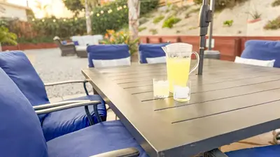a table with two glasses of orange juice on it at Oceanside Oasis - King Bed, Pet Friendly, Fire Pit in Oceanside