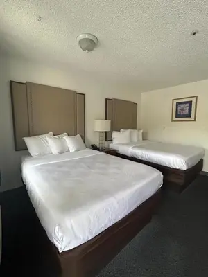two beds in a hotel room with two beds sidx sidx sidx at Back Country Inn in Boulevard