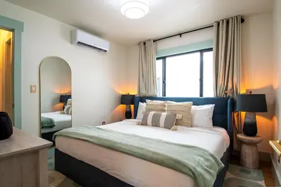 a bedroom with a large bed and a large window at The Boardwalk Hotel in San Diego