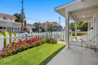 a white fence with a yard with flowers at Luxury on Lewis By Cardo - Jacuzzi Fire Pit in San Diego