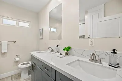 a white bathroom with a sink and a toilet at Luxury on Lewis By Cardo - Jacuzzi Fire Pit in San Diego